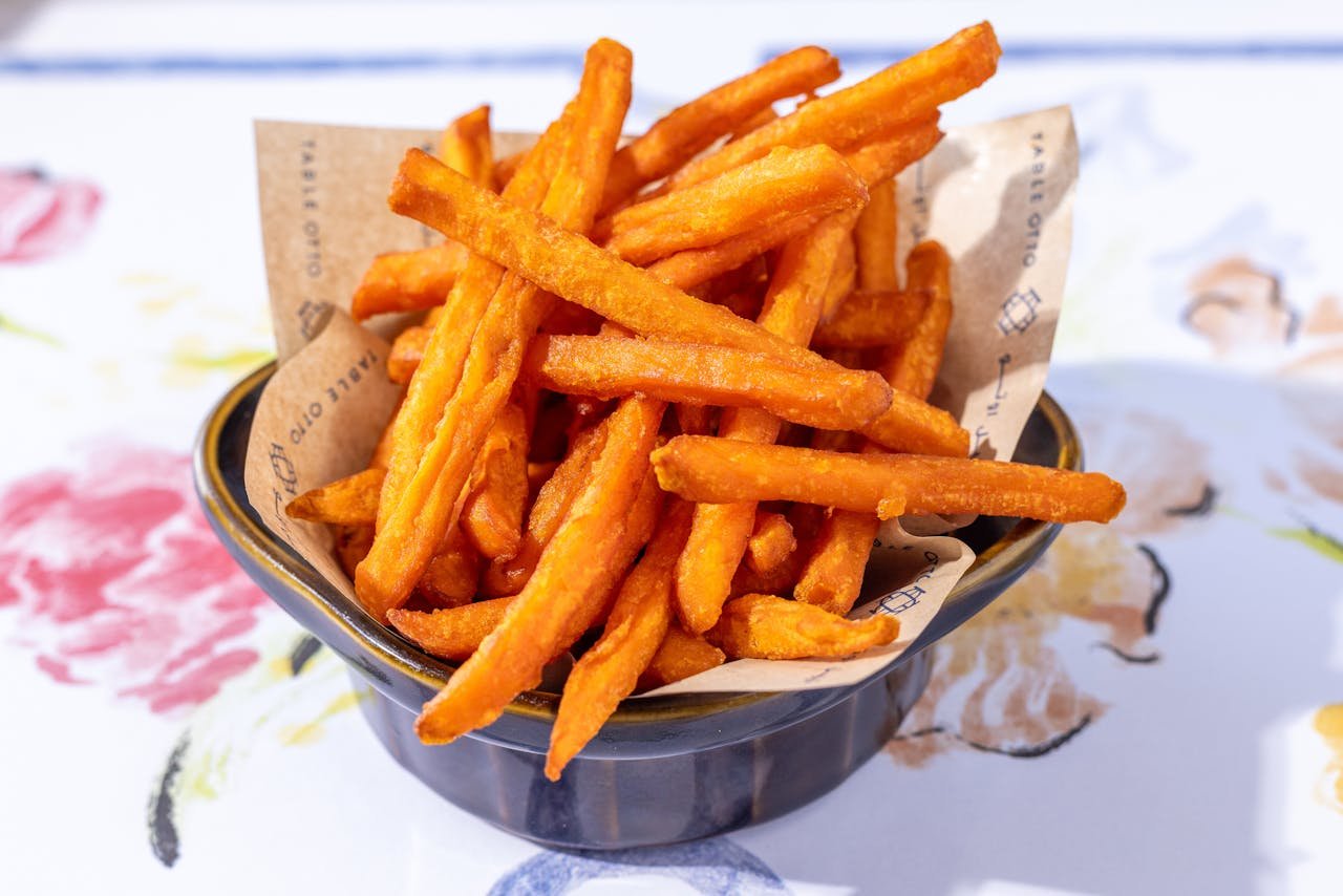 about-us Crispy sweet potato fries served in a bowl, perfect snack or side dish.