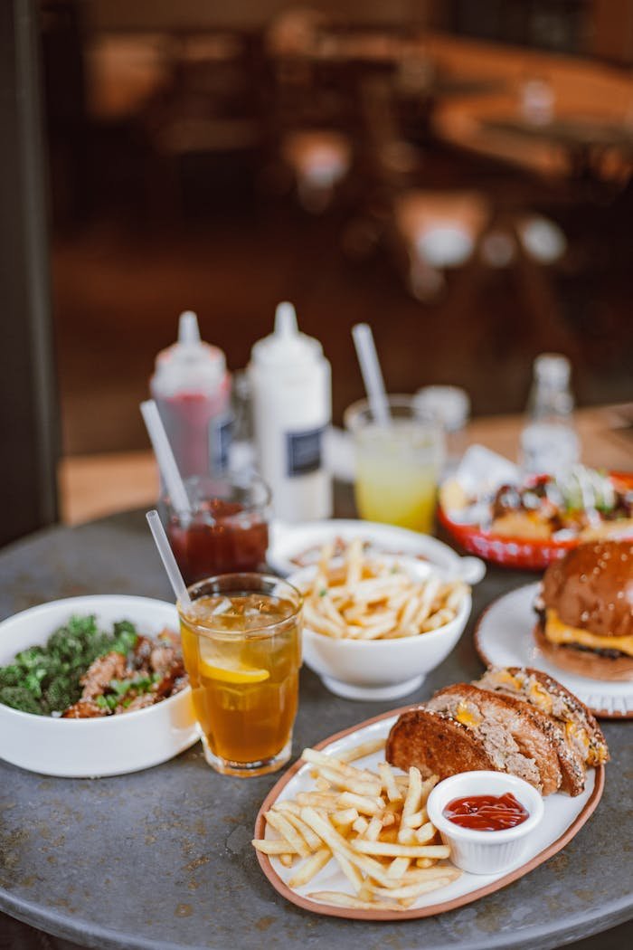 who-we-are Appetizing fast food spread with burgers, fries, and drinks on a table, perfect for dining visuals.