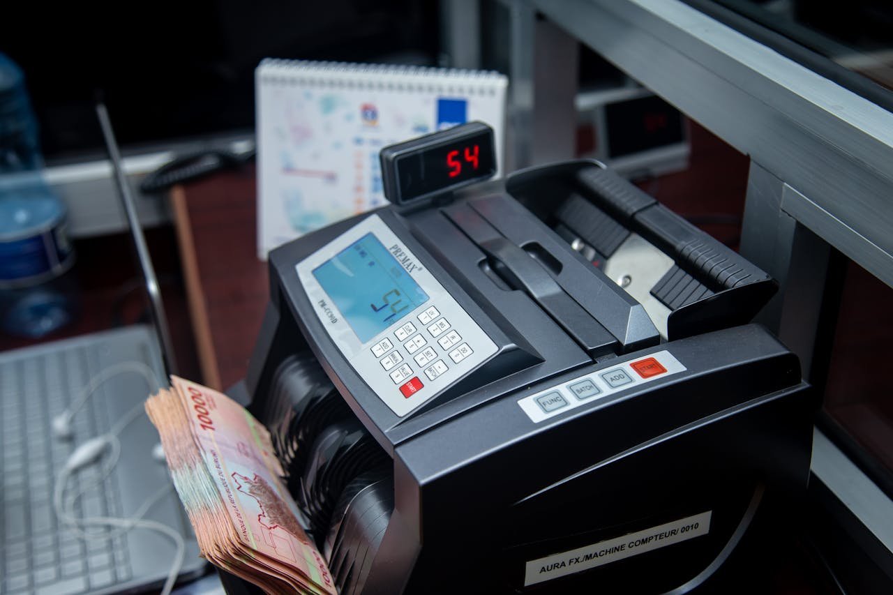 Automatic money counter in a modern office counting banknotes efficiently.